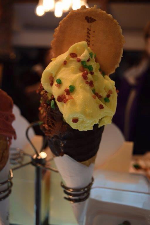 Mango gelato with chocolate waffle cone and sprinkles!